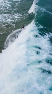 surfer catches wave