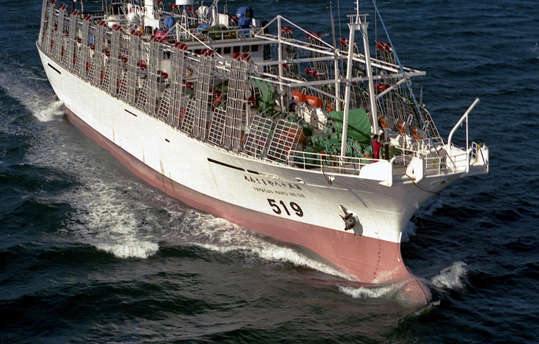 Image of large commercial fishing vessel using longliner techniques to catch fish, similar to those used in this study. Vessel is red and white coloring loaded with fishing equipment on deck and moving through open waters.