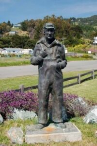 statue of man in overalls and hat